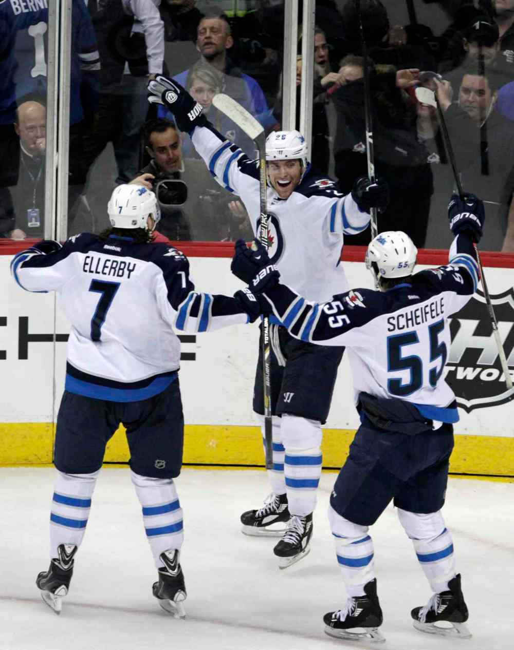 Joe Mahoney / The Associated Press
Winnipeg Jets winger Blake Wheeler (centre) celebrates scoring the game-winning goal with Jets defenceman Keaton Ellerby (left) and centre Mark Scheifele during the final seconds of overtime.