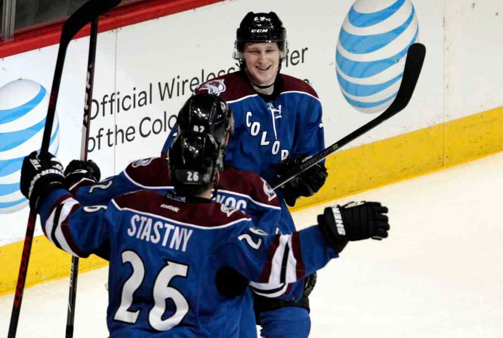 CP
Colorado Avalanche skater Nathan MacKinnon (top) celebrates scoring a goal with Avalanche forwards Gabriel Landeskog (centre) and Avalanche Paul Stastny during the third period.