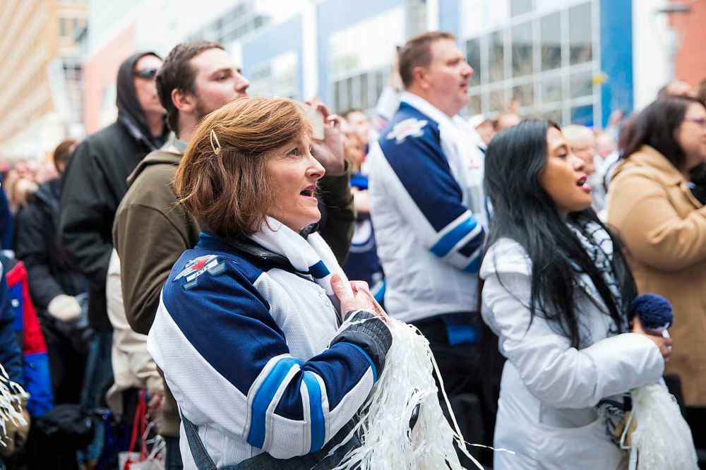 MIKAELA MACKENZIE / WINNIPEG FREE PRESS
Tammie Beauchemin sings the national anthem at the Jets whiteout party on Donald St.