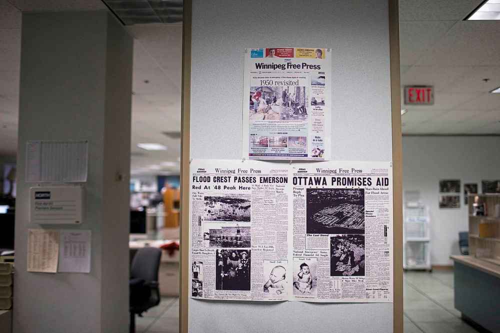 MIKAELA MACKENZIE / WINNIPEG FREE PRESS FILES
Papers from bygone days hang on the wall in the Winnipeg Free Press newsroom.