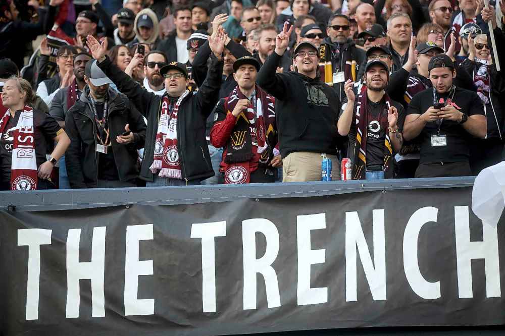 Fans in The Trench section of Investors Group Field celebrate after Valour FC's Micheal Petrasso scores the team's first goal at home, on a penalty kick, against FC Edmonton.