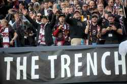 Fans in The Trench section of Investors Group Field celebrate after Valour FC