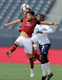 Member of Valour FC and FC Edmonton fight to take the ball.