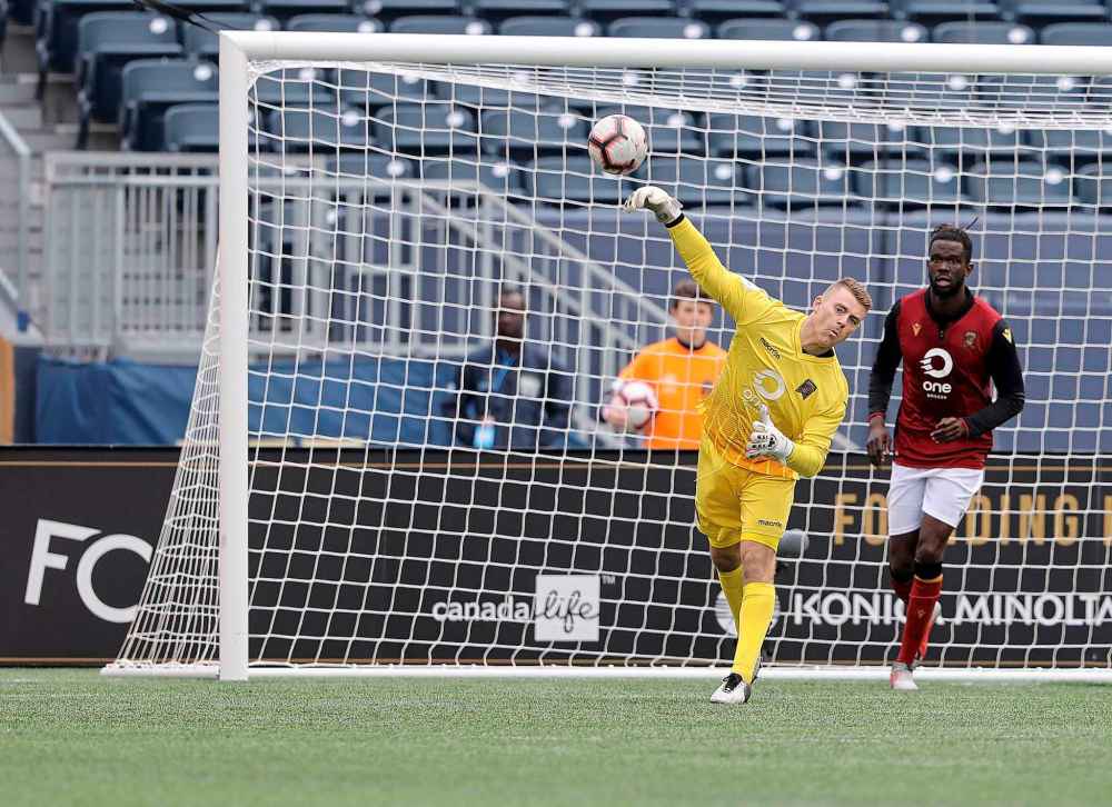 Valour FC goalkeeper Tyson Farago plays the ball against FC Edmonton.