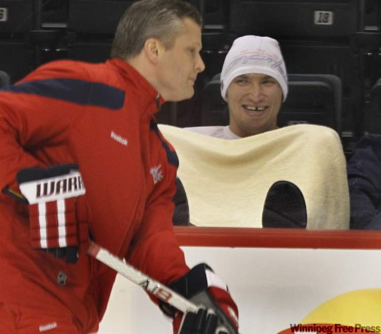 Wayne Glowacki / Winnipeg Free Press
Washington Capital captain Alex Ovechkin watches his team taking part in the optional practice at the MTS Centre in Winnipeg on Thursday as assistant coach Bob Woods skated by.