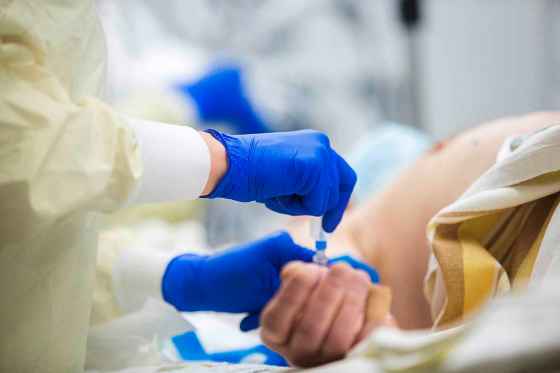 Health care workers run tests on a COVID-19 suspected patient in a resuscitation bay in the adult emergency department at the Health Sciences Centre in Winnipeg on Tuesday, Dec. 8, 2020.