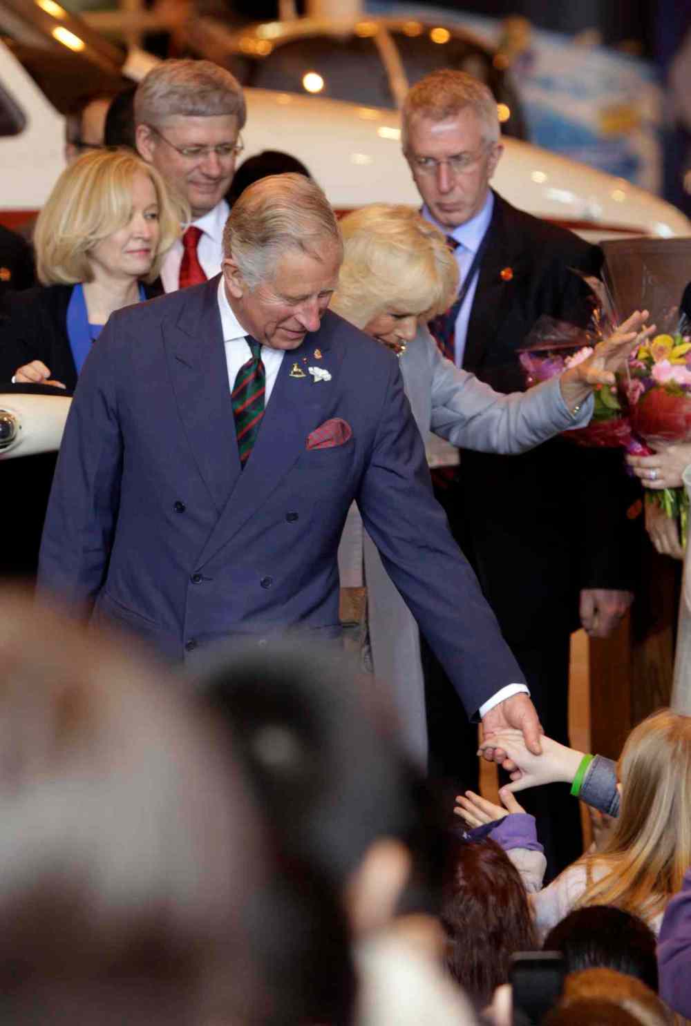 Prince Charles and Camilla, Duchess of Cornwall shake hands on their departure from the Stevenson Hangar Wednesday morning. Wayne Glowacki / Winnipeg Free Press May 21 2014