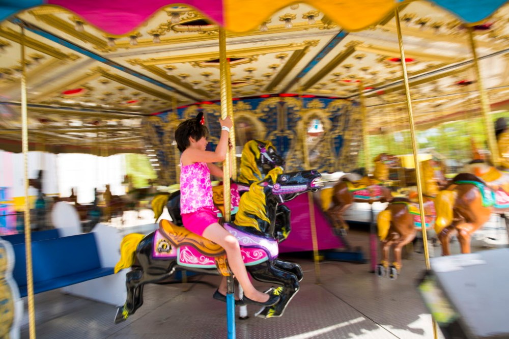 Mikaela MacKenzie / Winnipeg Free Press
Zoey Traverse, 7, rides the carousel at the Red River Ex on Friday. Traverse goes to the exhibition every year.