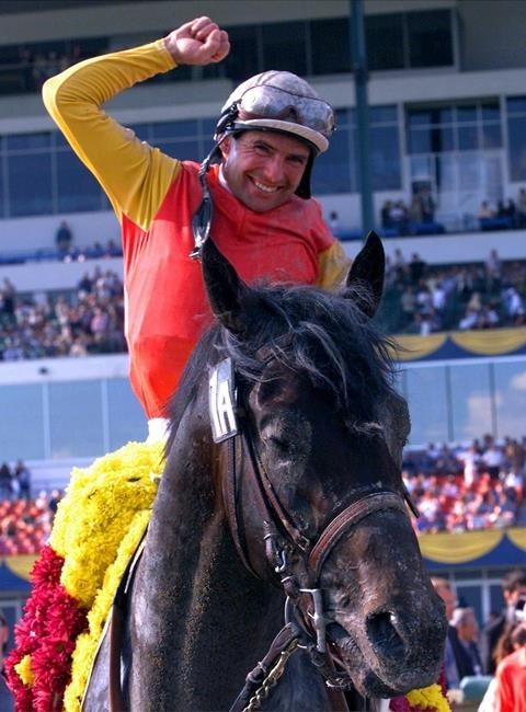 Kabel, aboard Scatter the Gold, celebrates winning the Queen's Plate in June 2000. (Frank Gunn / The Canadian Press files)