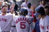 Boston Red Sox's Enrique Hernandez is greeted in the dugout after scoring during the eighth inning of a baseball game against the Detroit Tigers, Tuesday, April 12, 2022, in Detroit. (AP Photo/Carlos Osorio)
