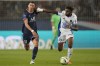 PSG's Angel Di Maria, left, and Troyes' Rominigue Kouame fight for the ball during the French League One soccer match between Paris Saint Germain and Troyes at the Parc des Princes stadium in Paris, Sunday, May 8, 2022. (AP Photo/Christophe Ena)