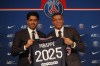 PSG striker Kylian Mbappe, right, shows his jersey with PSG president Nasser Al-Khelaifi during a press conference Monday, May 23, 2022 at the Paris des Princes stadium in Paris. Kylian Mbappé's decision to reject Real Madrid and commit to Paris Saint-Germain for three more seasons marks the start of a large rebuilding project at the French league champion. (AP Photo/Michel Spingler)