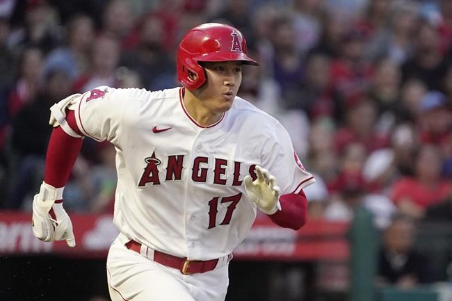 Los Angeles Angels' Shohei Ohtani runs to first as he grounds into a fielder's choice that allowed Andrew Velazquez to score during the third inning of a baseball game against the Toronto Blue Jays Thursday, May 26, 2022, in Anaheim, Calif. (AP Photo/Mark J. Terrill)