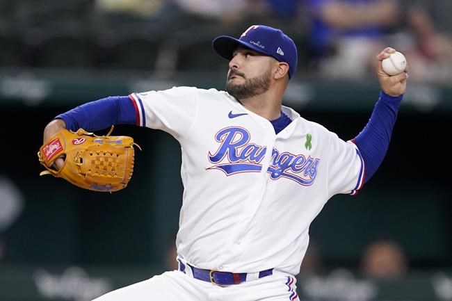 Texas Rangers starting pitcher Martin Perez throws to the Tampa Bay Rays in the first inning of a baseball game, Tuesday, May 31, 2022, in Arlington, Texas. (AP Photo/Tony Gutierrez)