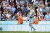 Manchester City's Kevin De Bruyne celebrates with the trophy after winning the 2022 English Premier League title at the Etihad Stadium in Manchester, England, Sunday, May 22, 2022. (AP Photo/Dave Thompson)