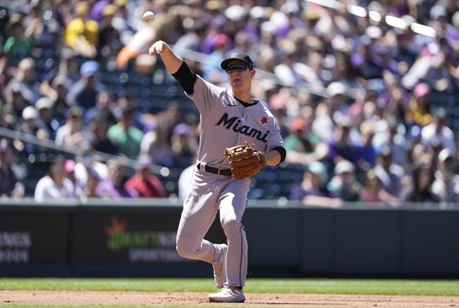 Miami Marlins third baseman Joey Wendle throws to first base to put out Colorado Rockies' Connor Joe in the first inning of a baseball game Monday, May 30, 2022, in Denver. (AP Photo/David Zalubowski)
