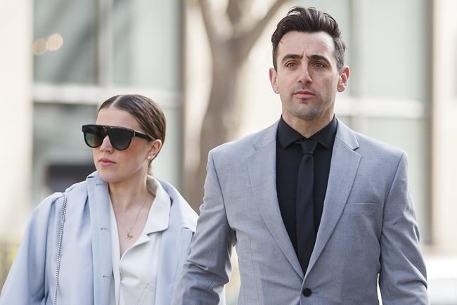 Canadian musician Jacob Hoggard arrives alongside his wife Rebekah Asselstine, for his sexual assault trial at the Toronto courthouse on Tuesday, May 10, 2022, in Toronto. THE CANADIAN PRESS/Cole Burston