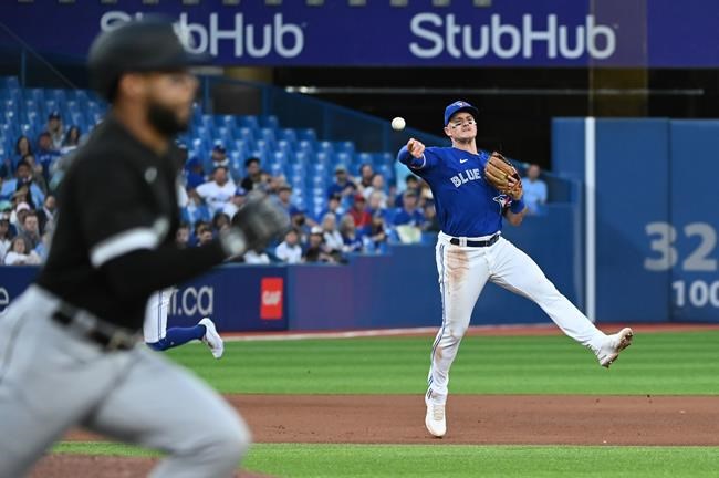 Toronto Blue Jays third baseball Matt Chapman (26), right, throws to first base to put out Chicago White Sox Leury Garcia, left, in the fourth inning of American League baseball action in Toronto on Wednesday, June 1, 2022. THE CANADIAN PRESS/Jon Blacker