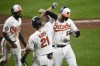 Baltimore Orioles' Trey Mancini, right, celebrates his two-run home run with Austin Hays (21) and Cedric Mullins, left, during the sixth inning of the team's baseball game against the Seattle Mariners, Wednesday, June 1, 2022, in Baltimore. (AP Photo/Nick Wass)
