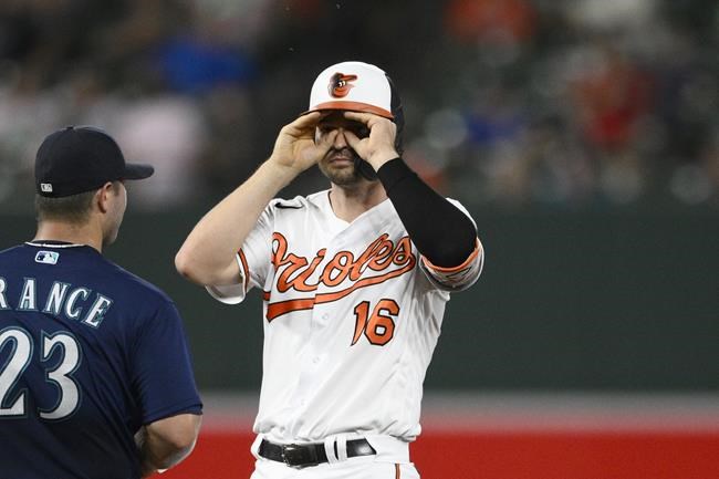 Baltimore Orioles' Trey Mancini (16) gestures next to Seattle Mariners first baseman Ty France (23) after he doubled during the fifth inning of a baseball game Wednesday, June 1, 2022, in Baltimore. (AP Photo/Nick Wass)