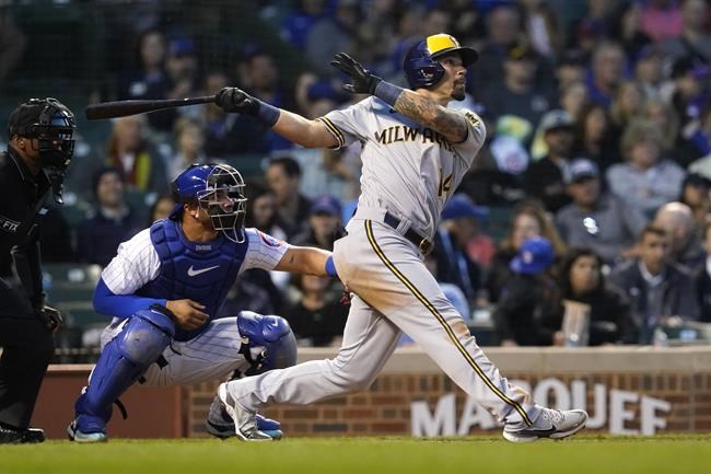 Milwaukee Brewers' Jace Peterson watches his RBI double off Chicago Cubs starting pitcher Kyle Hendricks during the fifth inning of a baseball game Wednesday, June 1, 2022, in Chicago. (AP Photo/Charles Rex Arbogast)