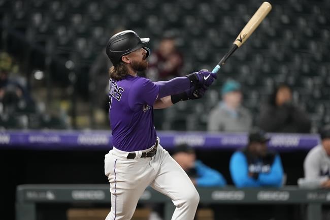 Colorado Rockies' Brendan Rodgers watches his two-run home run off Miami Marlins relief pitcher Cole Sulser during the 10th inning of the second game of a baseball doubleheader Wednesday, June 1, 2022, in Denver. (AP Photo/David Zalubowski)