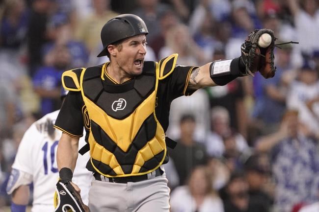 Pittsburgh Pirates catcher Tyler Heineman gestures toward center fielder Bryan Reynolds after Reynolds threw out Los Angeles Dodgers' Gavin Lux at home during the seventh inning of a baseball game Wednesday, June 1, 2022, in Los Angeles. (AP Photo/Mark J. Terrill)