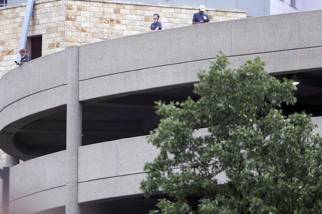 Spectators watch as Tulsa police and firefighters respond to a shooting at the Natalie Medical Building Wednesday, June 1, 2022. in Tulsa, Okla. Multiple people were shot at a Tulsa medical building on a hospital campus Wednesday. (Ian Maule/Tulsa World via AP)