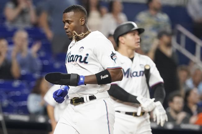 Miami Marlins Jorge Soler scores on a double by Jesus Aguilar during the sixth inning of a baseball game against the San Francisco Giants, Thursday, June 2, 2022, in Miami. (AP Photo/Marta Lavandier)