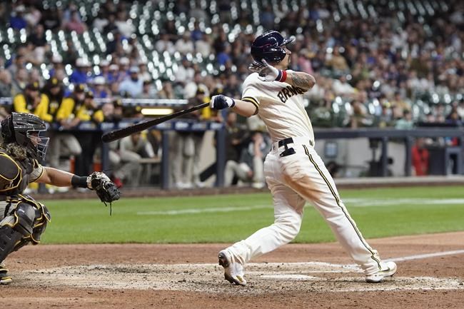 Milwaukee Brewers' Jace Peterson hits a three-run scoring triple during the ninth inning of a baseball game against the San Diego Padres Thursday, June 2, 2022, in Milwaukee. (AP Photo/Morry Gash)