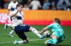 Vancouver Whitecaps Brian White, left, is stopped by Sporting Kansas City goalkeeper Tim Melia during the first half of an MLS soccer game in Vancouver, on Saturday, April 2, 2022. THE CANADIAN PRESS/Darryl Dyck