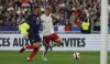 Denmark's Andreas Cornelius, right, scores his side's second goal during the UEFA Nations League soccer match between France and Denmark at the Stade de France in Saint Denis near Paris, France, Friday, June 3, 2022. (AP Photo/Jean-Francois Badias)