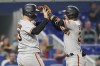 San Francisco Giants Joc Pederson (23) congratulates Thairo Estrada (39) after Estrada hit a two-run-home-run in the fifth inning of a baseball game against the Miami Marlins, Friday, June 3, 2022, in Miami. Pederson hit a solo home run in the third inning. (AP Photo/Marta Lavandier)