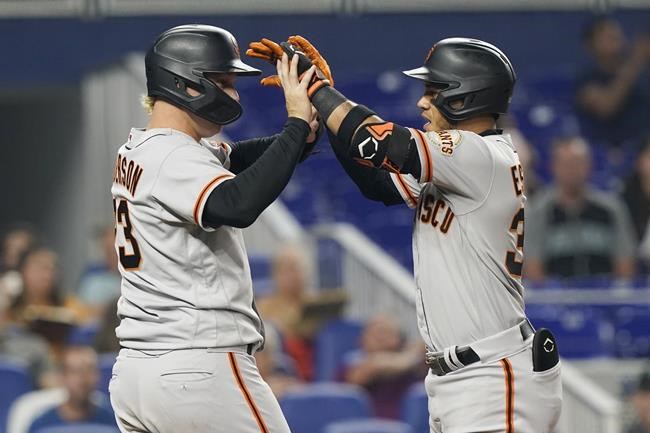 San Francisco Giants Joc Pederson (23) congratulates Thairo Estrada (39) after Estrada hit a two-run-home-run in the fifth inning of a baseball game against the Miami Marlins, Friday, June 3, 2022, in Miami. Pederson hit a solo home run in the third inning. (AP Photo/Marta Lavandier)