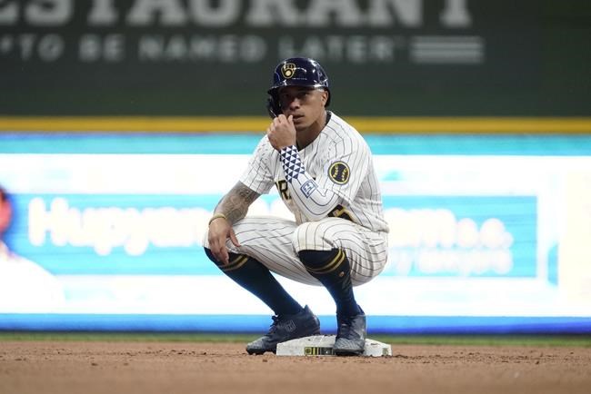 Milwaukee Brewers' Kolten Wong sits on second after hitting a double during the eighth inning of a baseball game against the San Diego Padres Friday, June 3, 2022, in Milwaukee. (AP Photo/Morry Gash)