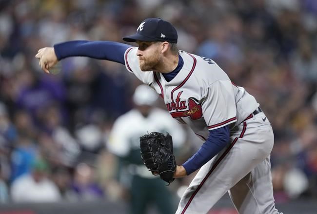 Atlanta Braves relief pitcher Collin McHugh works against the Colorado Rockies during the seventh inning of a baseball game Saturday, June 4, 2022, in Denver. (AP Photo/David Zalubowski)