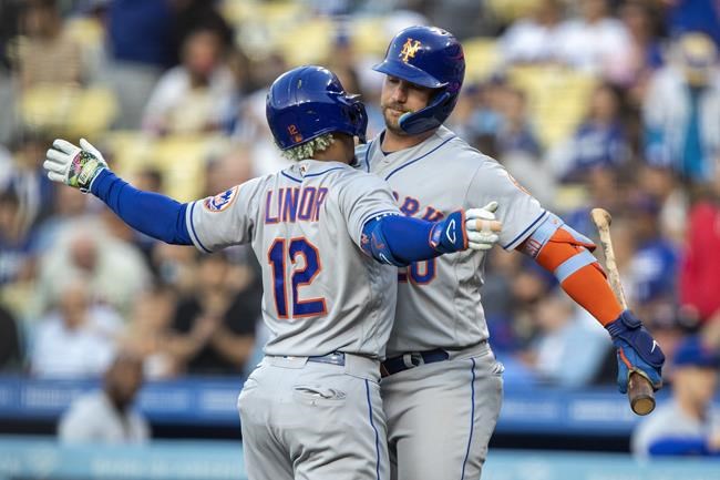 New York Mets' Pete Alonso, right, celebrates with Francisco Lindor after Lindor hit a solo home run against the Los Angeles Dodgers during the first inning of a baseball game in Los Angeles, Saturday, June 4, 2022. (AP Photo/Alex Gallardo)