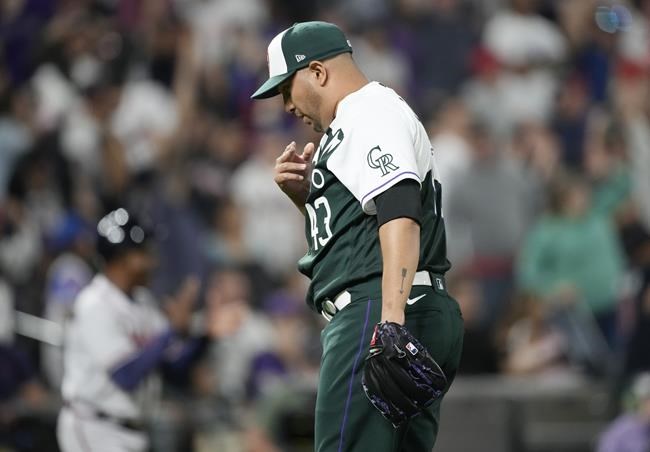 Colorado Rockies relief pitcher Jhoulys Chacin pauses after giving up a two-run home run to Atlanta Braves' Adam Duvall during the 11th inning of a baseball game Saturday, June 4, 2022, in Denver. (AP Photo/David Zalubowski)