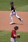 Pittsburgh Pirates' Cal Mitchell, top, rounds the bases after hitting a solo home run off Arizona Diamondbacks starting pitcher Zac Gallen, bottom, during the fifth inning of a baseball game in Pittsburgh, Sunday, June 5, 2022. (AP Photo/Gene J. Puskar)