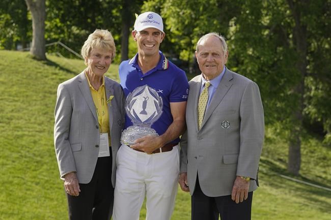 Billy Horschel, center, poses with Jack and Barbara Nicklaus after Horschel won the Memorial golf tournament Sunday, June 5, 2022, in Dublin, Ohio. (AP Photo/Darron Cummings)