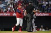 Los Angeles Angels' manager Joe Maddon, left, disputes a stolen base call during the fifth inning of a baseball game against the Boston Red Sox in Anaheim, Calif., Monday, June 6, 2022. (AP Photo/Ashley Landis)