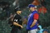 Home plate umpire Mark Wegner, left, talks with Chicago Cubs manager David Ross during the fourth/fifth inning of a baseball game against the Baltimore Orioles, Tuesday, June 7, 2022, in Baltimore. (AP Photo/Julio Cortez)