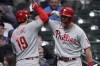 Philadelphia Phillies' Matt Vierling (19) is congratulated by Rhys Hoskins after hitting a go-ahead home run during the ninth inning of the team's baseball game against the Milwaukee Brewers on Tuesday, June 7, 2022, in Milwaukee. (AP Photo/Aaron Gash)