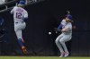 New York Mets left fielder Jeff McNeil, right, can't make the catch on a ball hit by San Diego Padres' Manny Machado, as Mets shortstop Francisco Lindor (12) watches during the fifth inning of a baseball game Tuesday, June 7, 2022, in San Diego. McNeil was charged with an error. (AP Photo/Gregory Bull)