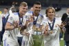 Real Madrid's Luka Modric, right, Real Madrid's Casemiro, center, and Real Madrid's Toni Kroos pose for a photograph with the trophy after winning the Champions League final soccer match between Liverpool and Real Madrid at the Stade de France in Saint Denis near Paris, Sunday, May 29, 2022. (AP Photo/Kirsty Wigglesworth)