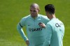 Portugal's Cristiano Ronaldo and Pepe, left, have a chat before the start of a training session of the Portuguese soccer team in Oeiras, outside Lisbon, Wednesday, June 8, 2022. Portugal will face the Czech Republic June 9 in a Nations League match in Lisbon. (AP Photo/Armando Franca)