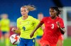 Sweden's Kosovare Asllani, left, and Canada's Kadeisha Buchanan battle for the ball during the women's final soccer match at the 2020 Summer Olympics, Friday, Aug. 6, 2021, in Yokohama, Buchanan has signed a three-year deal with English soccer giant Chelsea. Buchanan joins the storied London club's women's team after a highly successful run with Lyon. THE CANADIAN PRESS/AP-Andre Penner