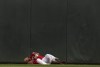 Minnesota Twins centerfielder Royce Lewis lies on the field after catching a fly ball hit by Kansas City Royals' Emmanuel Rivera in the sixth inning of a baseball game in Minneapolis, Sunday, May 29, 2022. Lewis was injured on the play after he collided with the wall. (Jerry Holt/Star Tribune via AP)