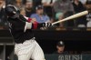 Chicago White Sox's Yasmani Grandal hits a two-run double during the eighth inning of a baseball game against the Texas Rangers in Chicago, Friday, June 10, 2022. (AP Photo/Nam Y. Huh)