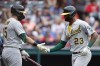 Oakland Athletics' Christian Bethancourt (23) celebrates with Seth Brown (15) after hitting a solo home run against the Cleveland Guardians during the ninth inning of a baseball game Saturday, June 11, 2022, in Cleveland. (AP Photo/Ron Schwane)